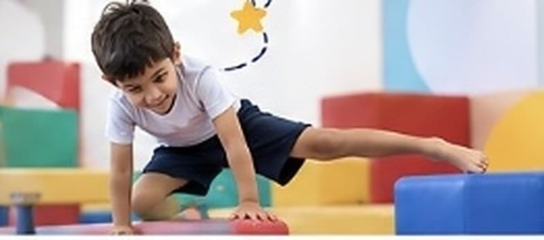 Young gymnasts training together in a bright hall