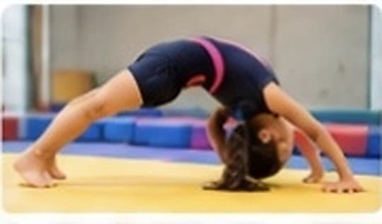 Child training with gymnastics coaches